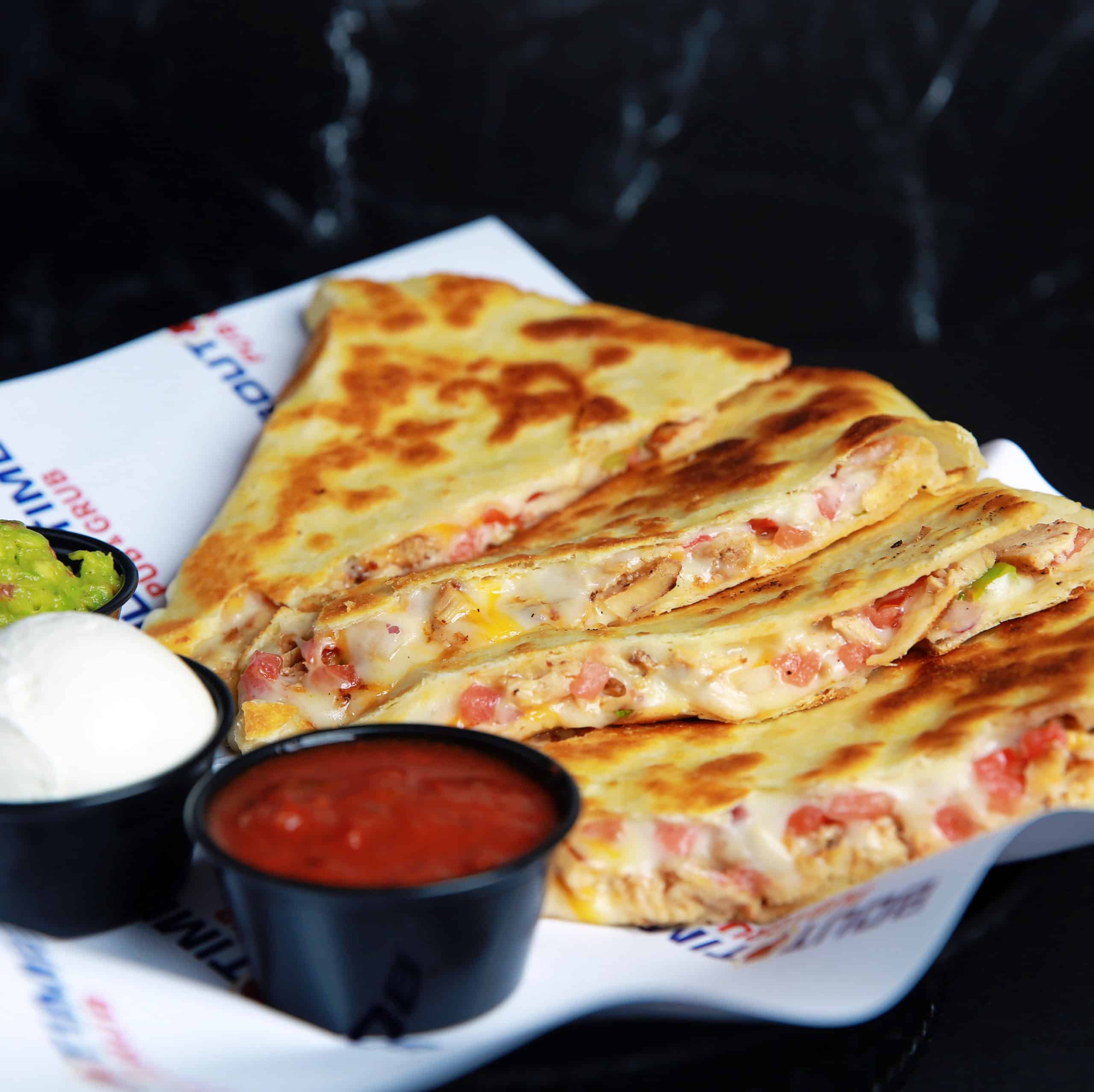 A flour tortilla stuffed with cheese and Pico de Gallo. Griddled to a golden brown and served with sour cream, salsa and fresh guacamole. Choose either chicken or steak.