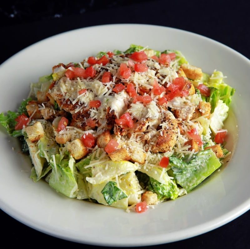 Salad greens tossed with grilled chicken, Parmesan cheese, croutons, tomato and a creamy Caesar dressing (no choice of dressing)